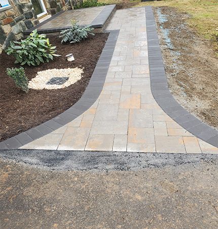Walkway Pavers Connected to Driveway Leading to Entrance of Home